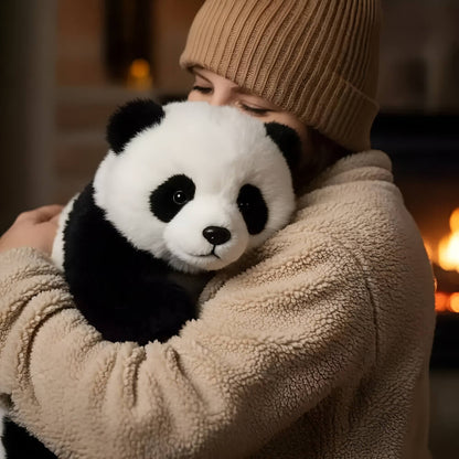 Person wearing a beige hat and coat holding a plush panda toy in front of a fireplace.